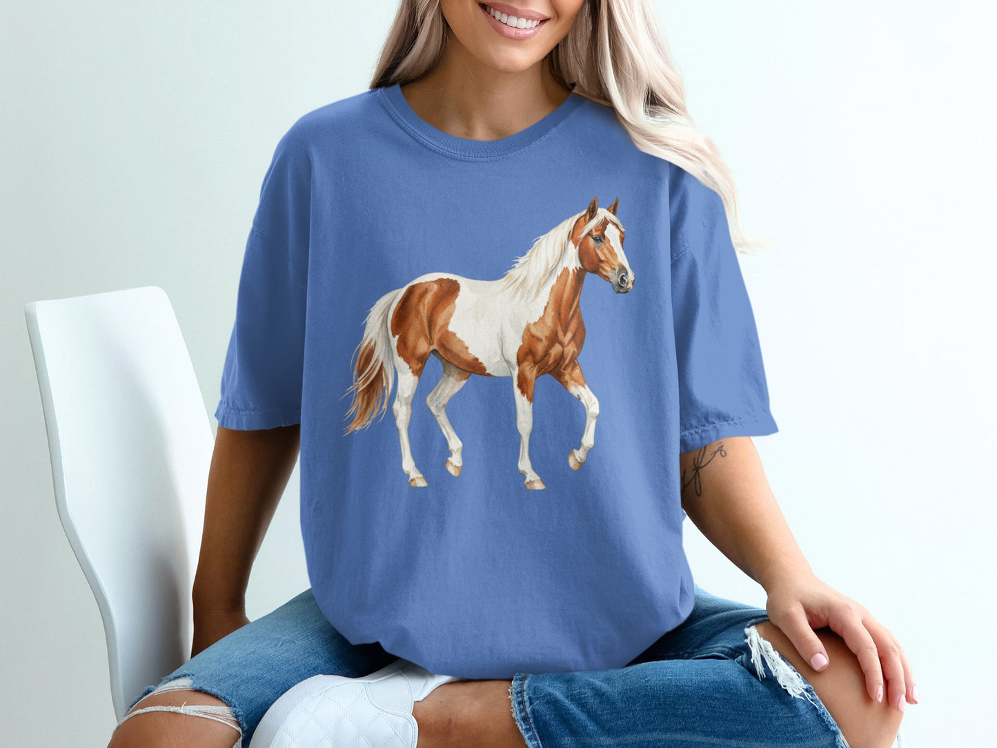 Blue t-shirt with a watercolor painting of a pinto horse.
