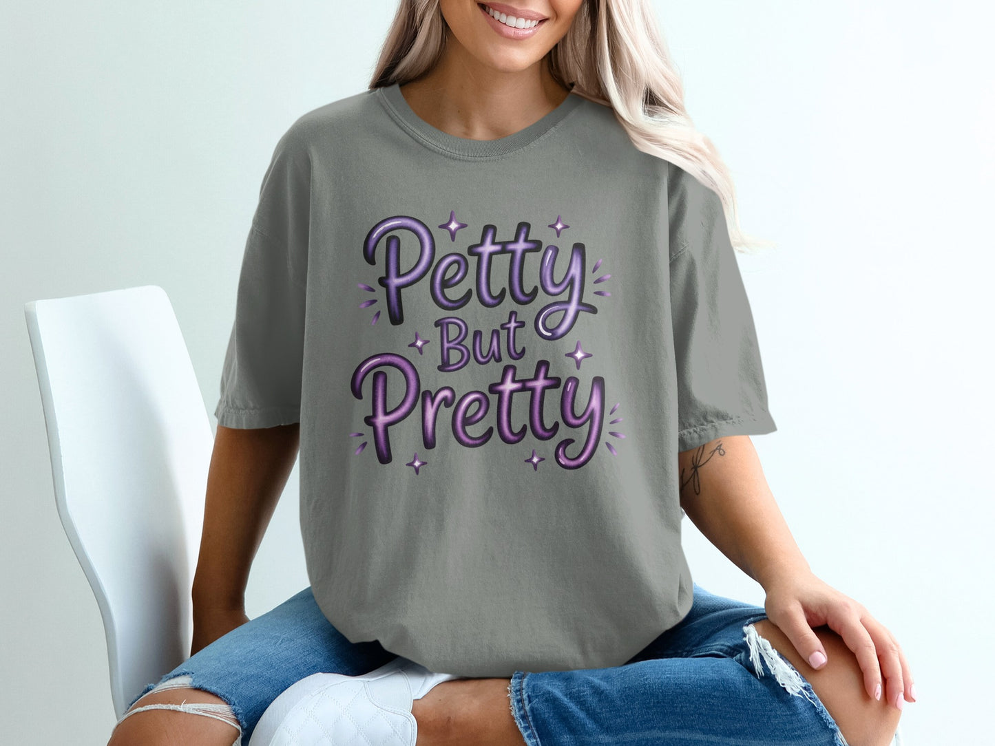 Grey t-shirt with "Petty But Pretty" text in purple gradient lettering.