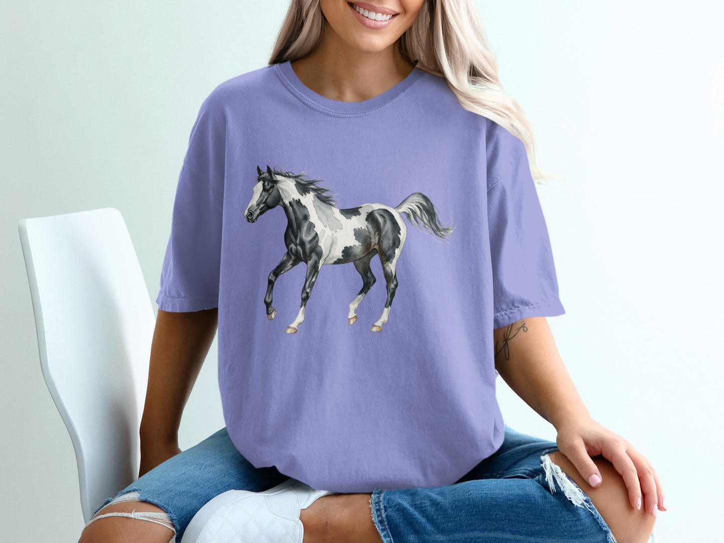 Purple t-shirt with black and white horse graphic.