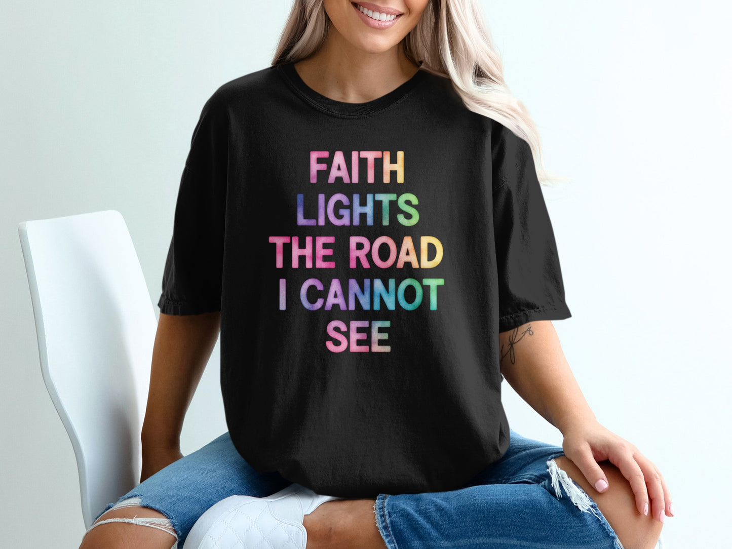 Black t-shirt with "FAITH LIGHTS THE ROAD I CANNOT SEE" in colorful text.