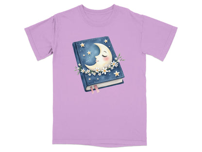 Lavender t-shirt featuring a closed book with a crescent moon resting on it.