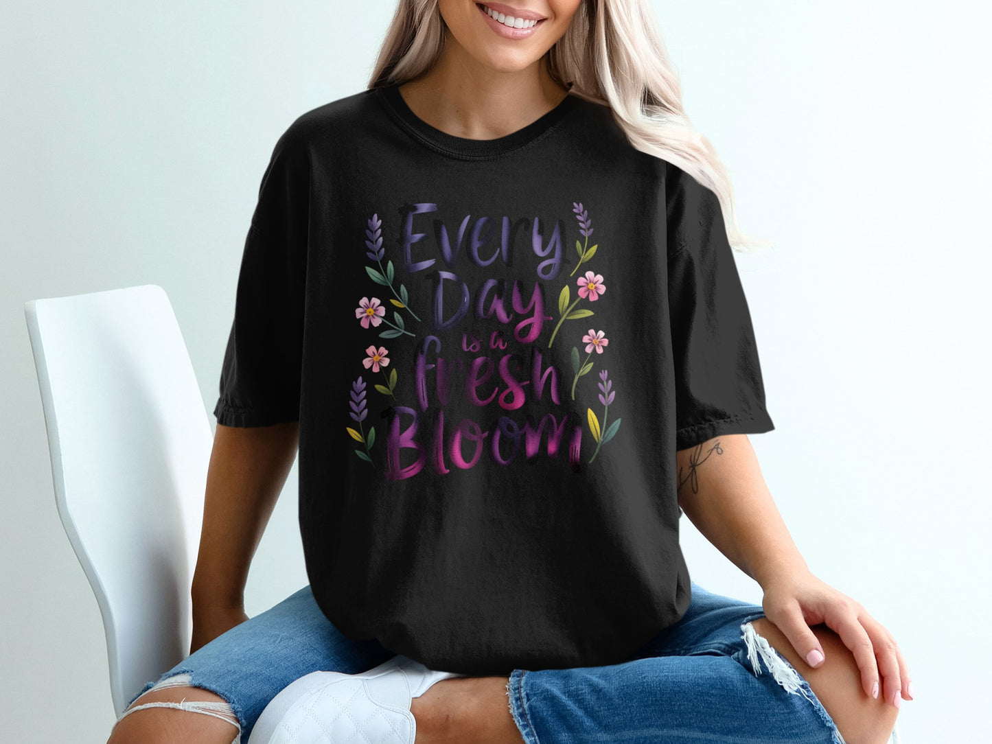 Black t-shirt with "Every Day is a Fresh Bloom" text and floral accents.
