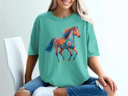 Teal t-shirt with a colorful, decorative horse graphic.