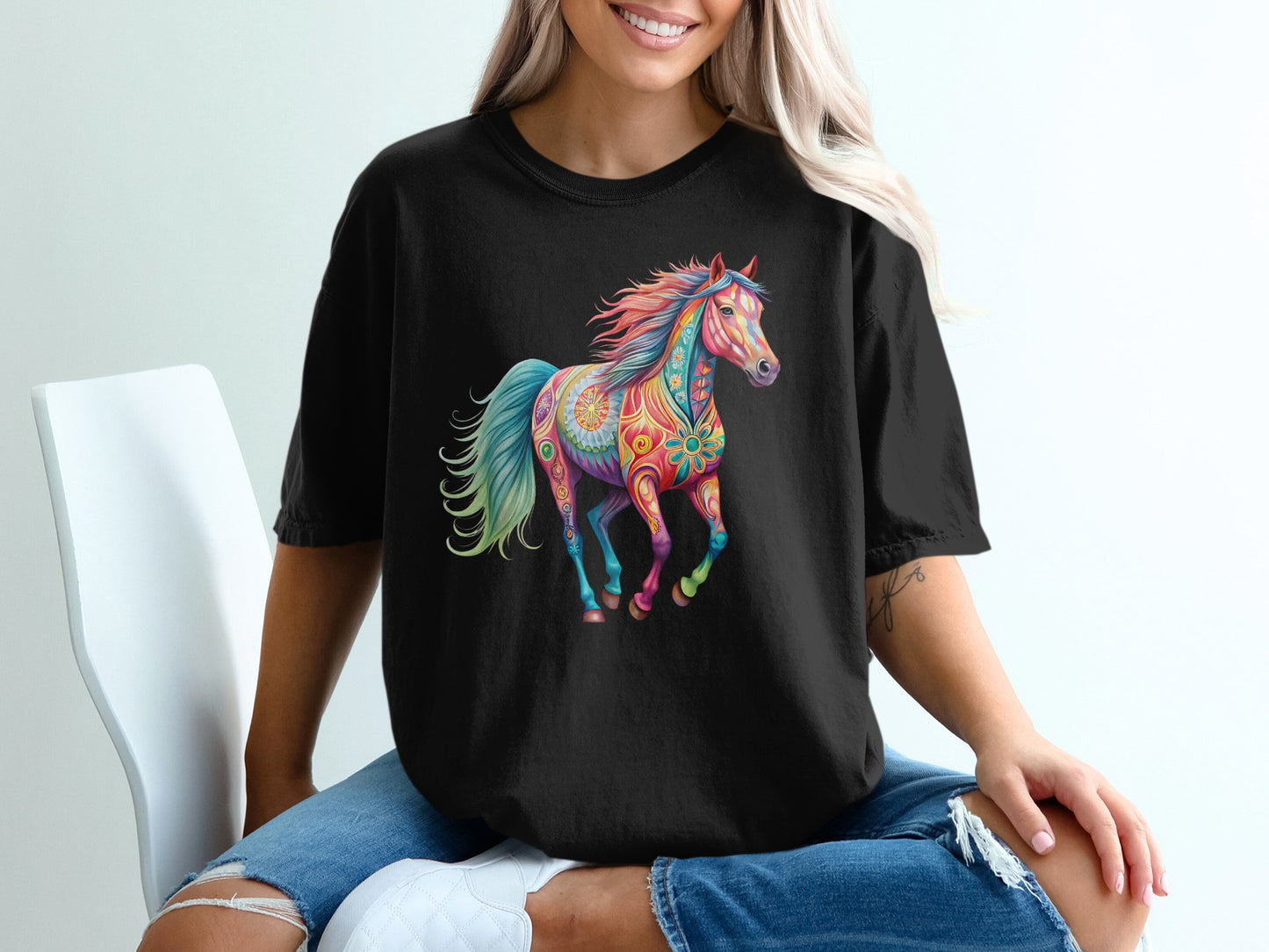 Black t-shirt with a colorful, patterned horse graphic.