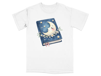 White t-shirt with a graphic of a closed book featuring a moon and stars.