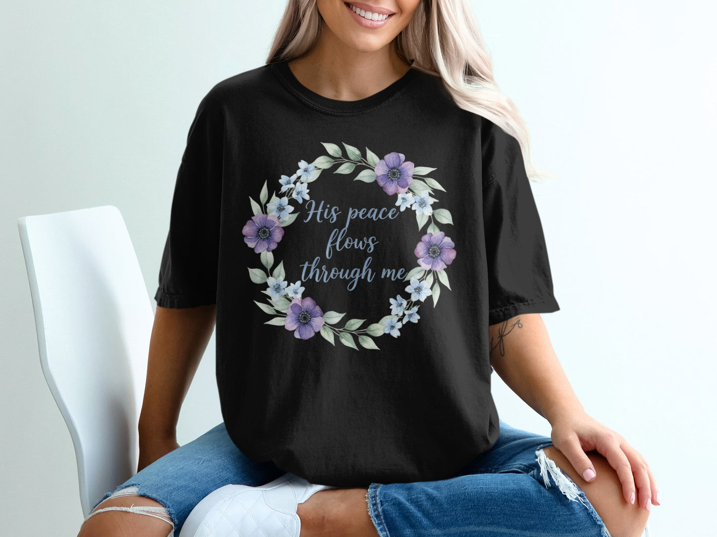 Black t-shirt with floral wreath and "His peace flows through me" text.
