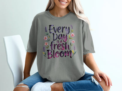Gray t-shirt with purple "Every Day is a Fresh Bloom" text and floral accents.