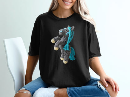 Black t-shirt with a crocheted horse graphic featuring blue mane and tail.