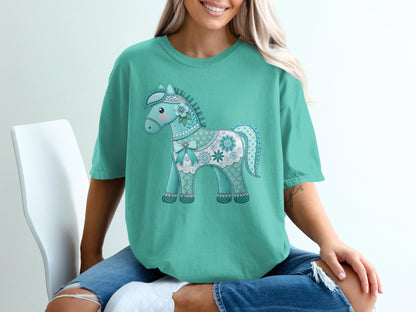 Teal t-shirt with a decorative teal and white horse graphic.