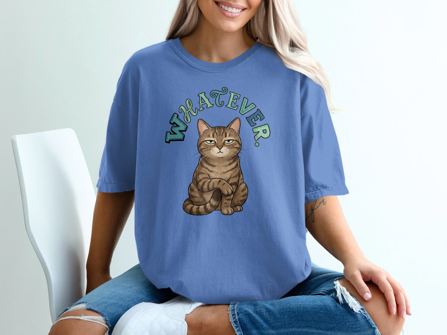Blue t-shirt with "WHATEVER" text and a grumpy cat illustration.