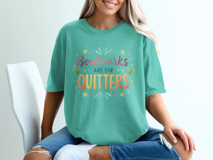 Teal t-shirt with "Bookmarks are for quitters" text in colorful lettering.