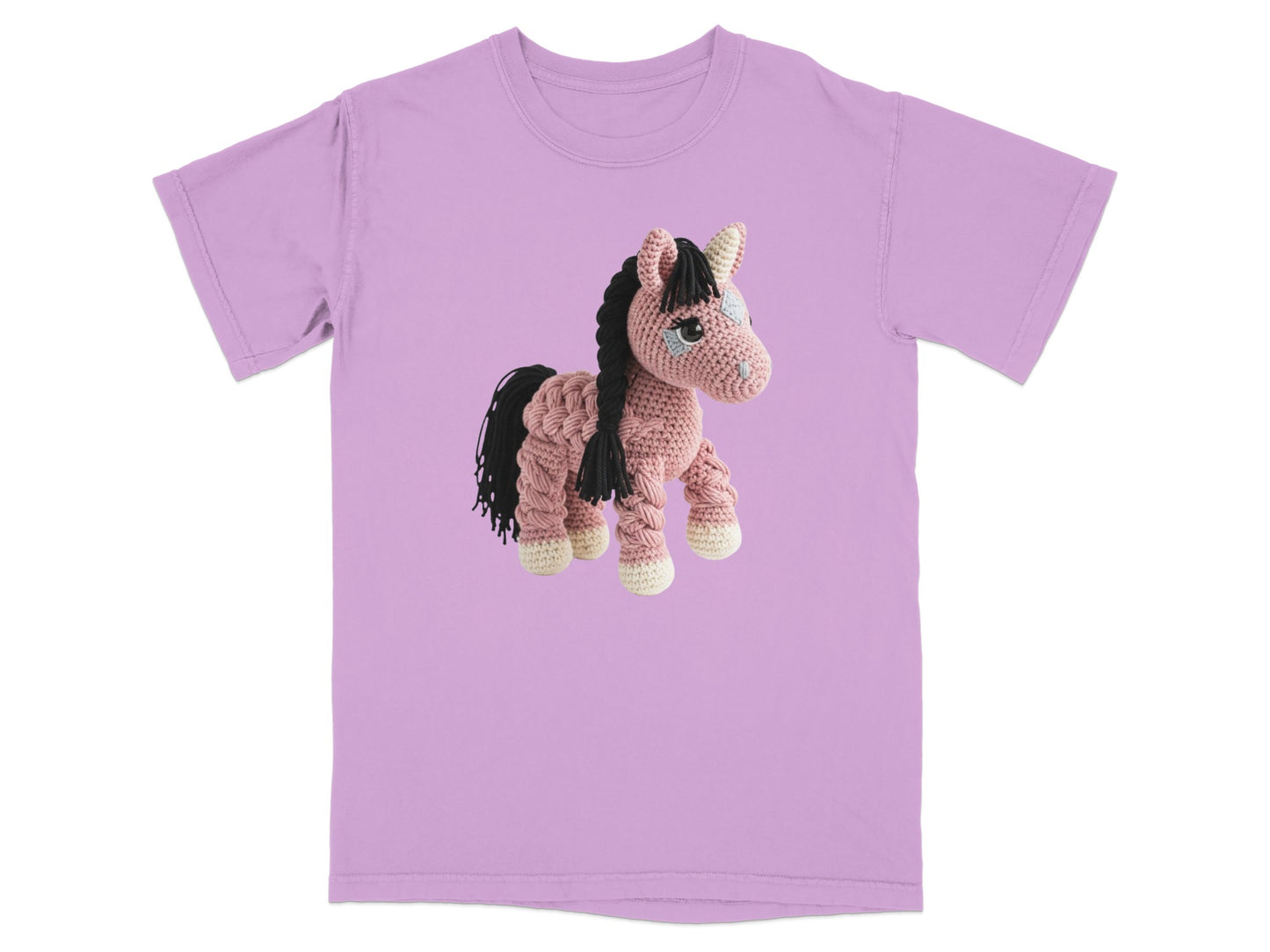 Crocheted pink horse with black mane and tail on a lavender t-shirt.