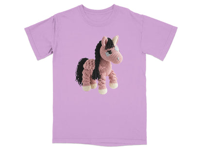 Crocheted pink horse with black mane and tail on a lavender t-shirt.