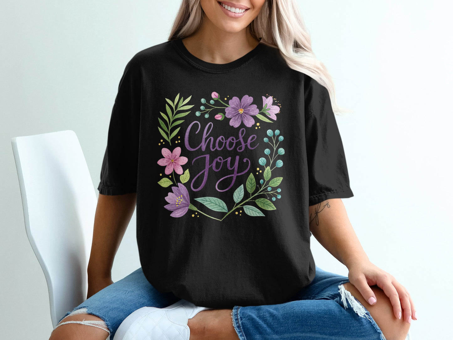 Black t-shirt with "Choose Joy" text surrounded by floral and leafy design.