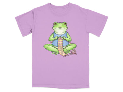 Frog knitting a striped scarf, wearing a blue vest.