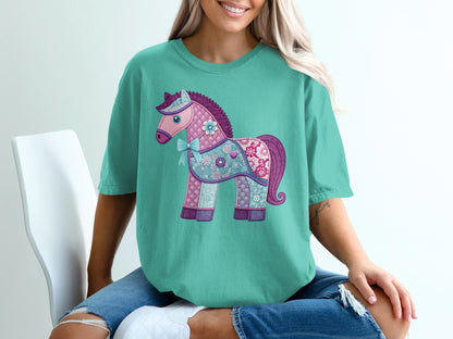 Teal t-shirt with a colorful quilted horse graphic and bow.