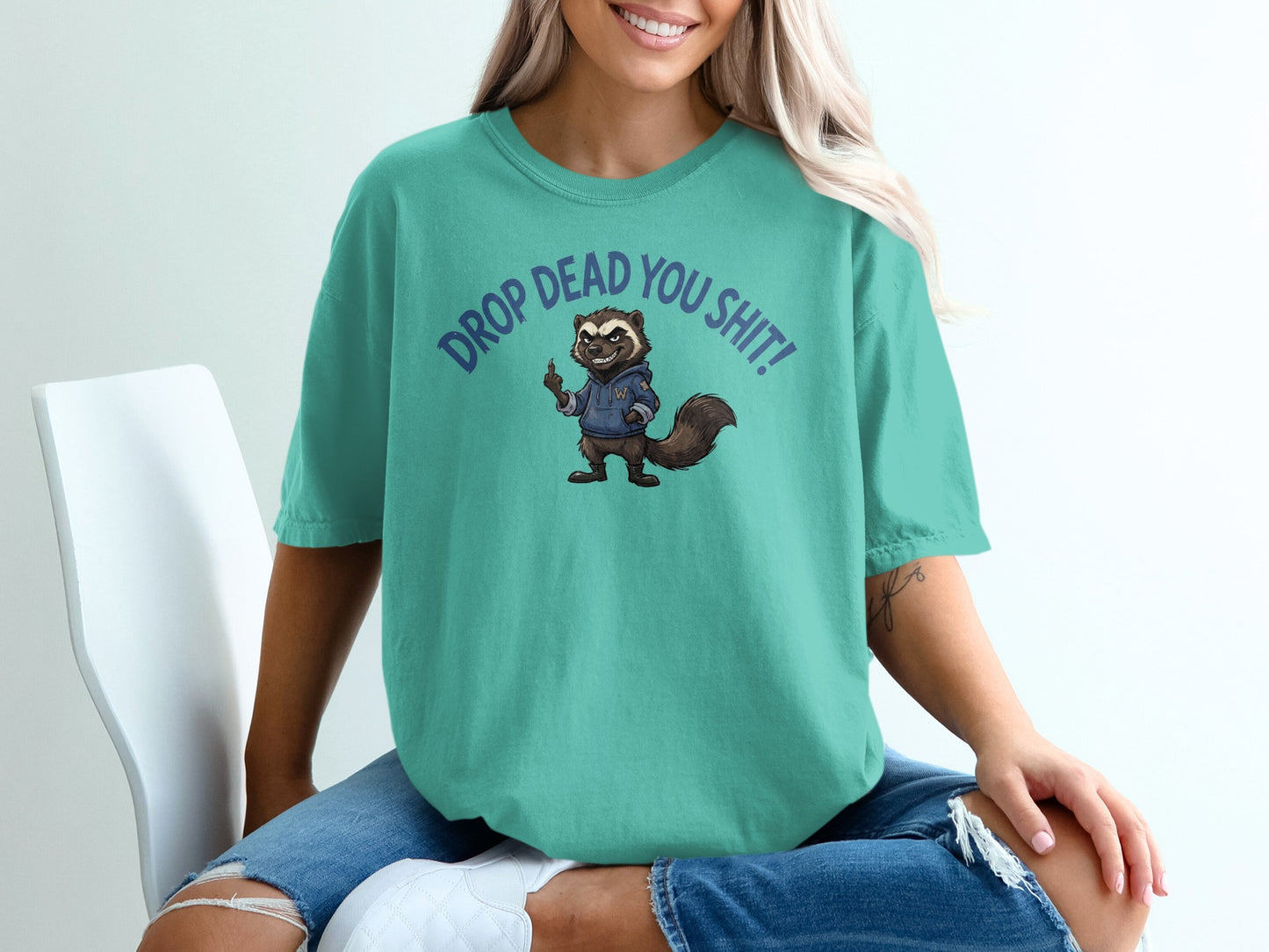 Teal t-shirt with cartoon raccoon and text "DROP DEAD YOU SH!T!".