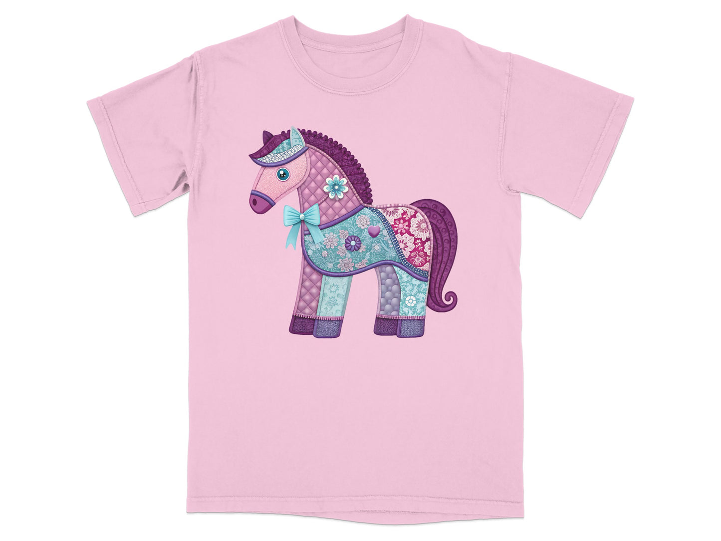 Pink t-shirt with a patchwork-style unicorn and a blue bow.