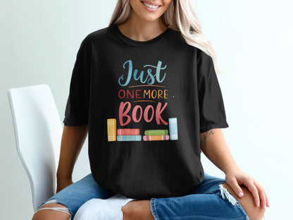 Black t-shirt with "Just ONE MORE BOOK" text and colorful book spine graphic.