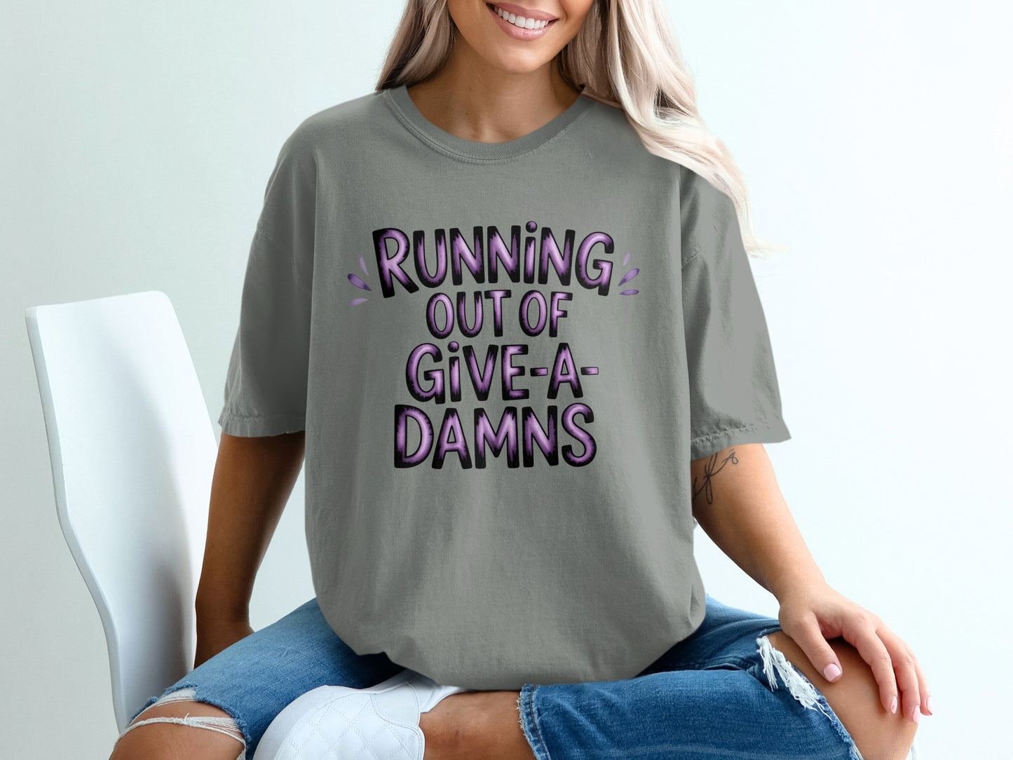 Grey t-shirt with purple "Running out of Give-a-Damns" text.