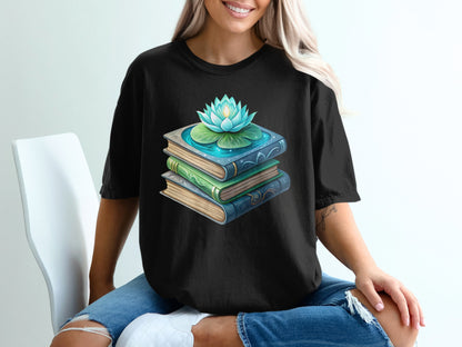 Black t-shirt with stacked books and a blooming lotus flower graphic.