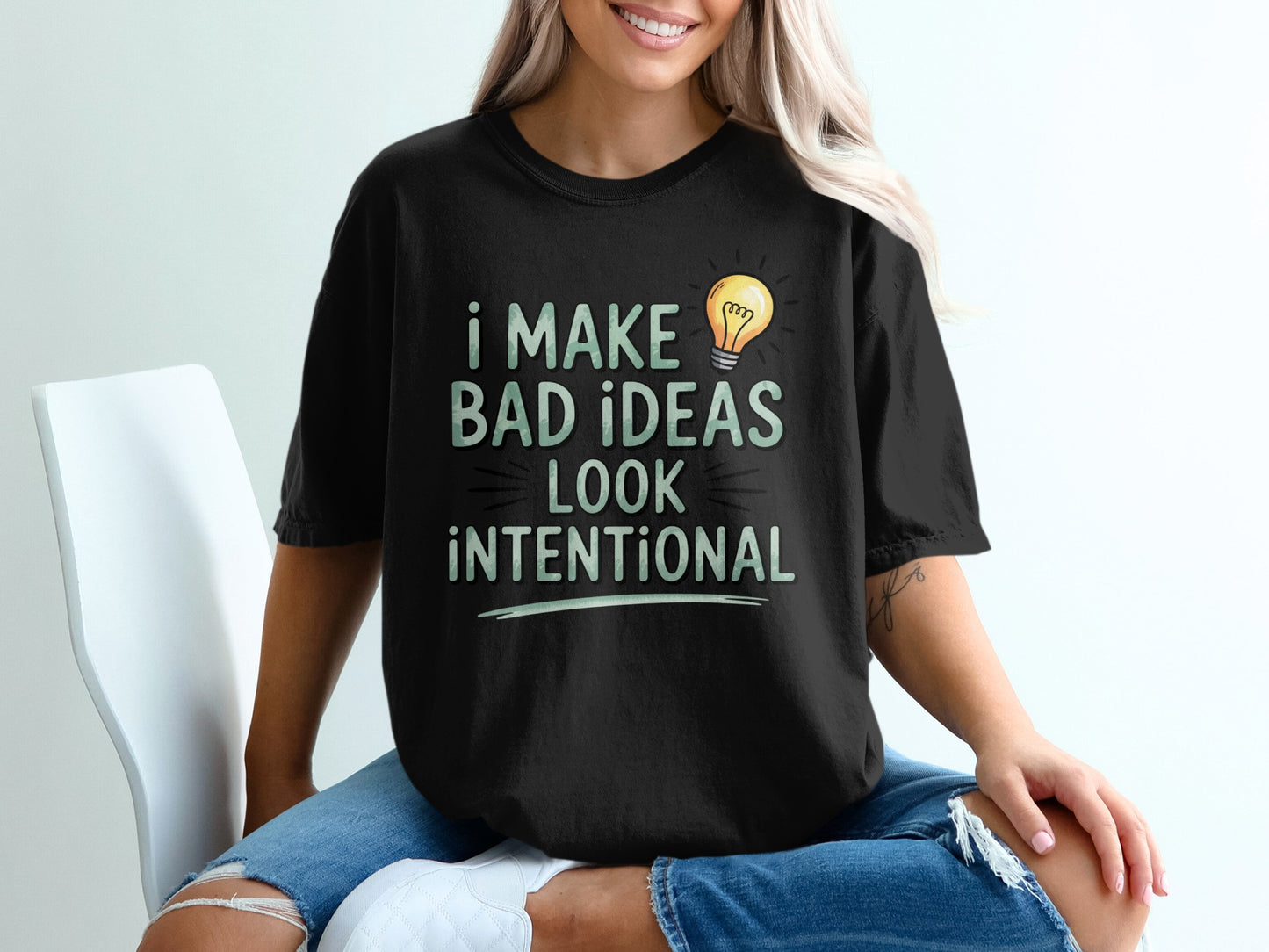 Black t-shirt with "I make bad ideas look intentional" and a lightbulb graphic.