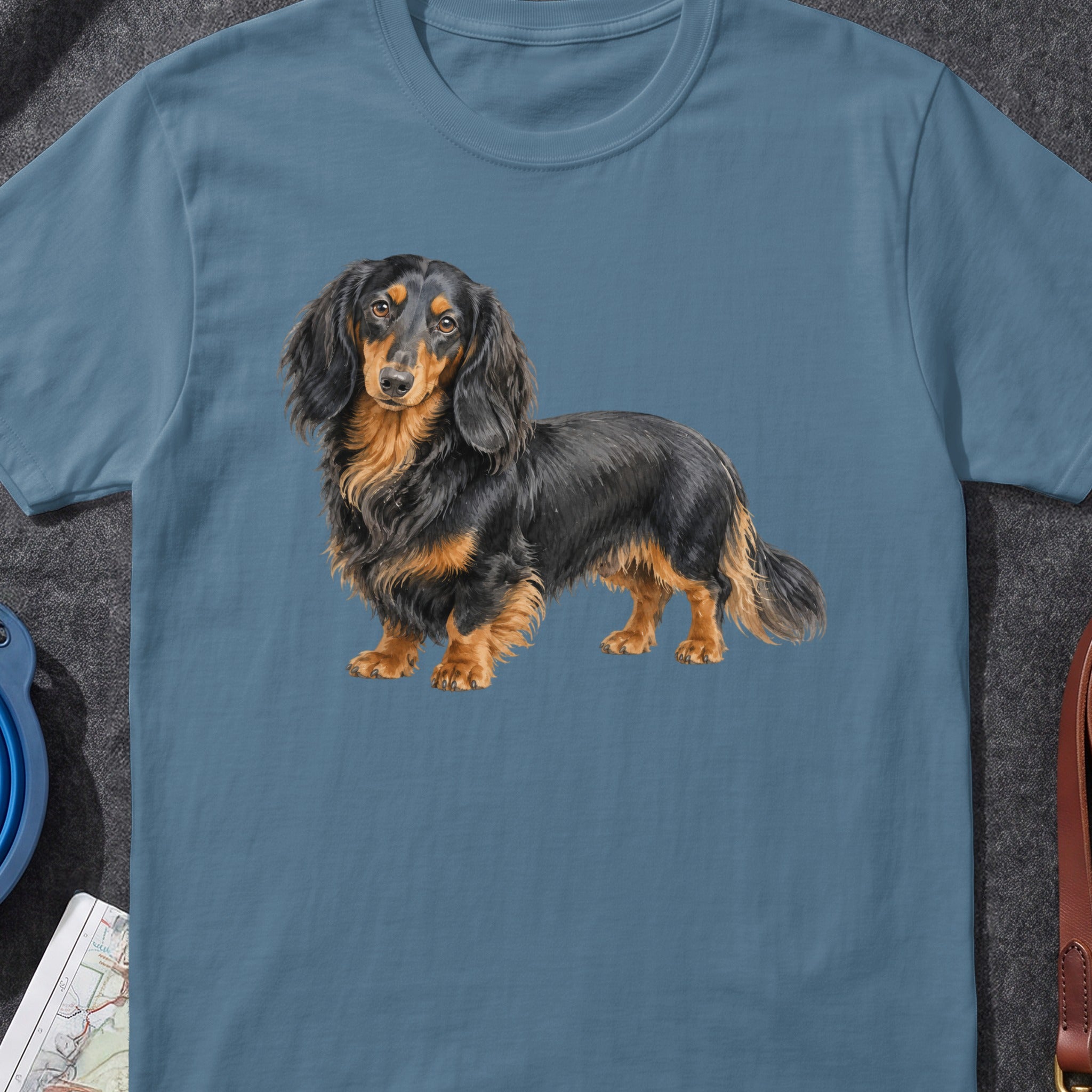 Long-haired black and tan dachshund illustration on a blue t-shirt.