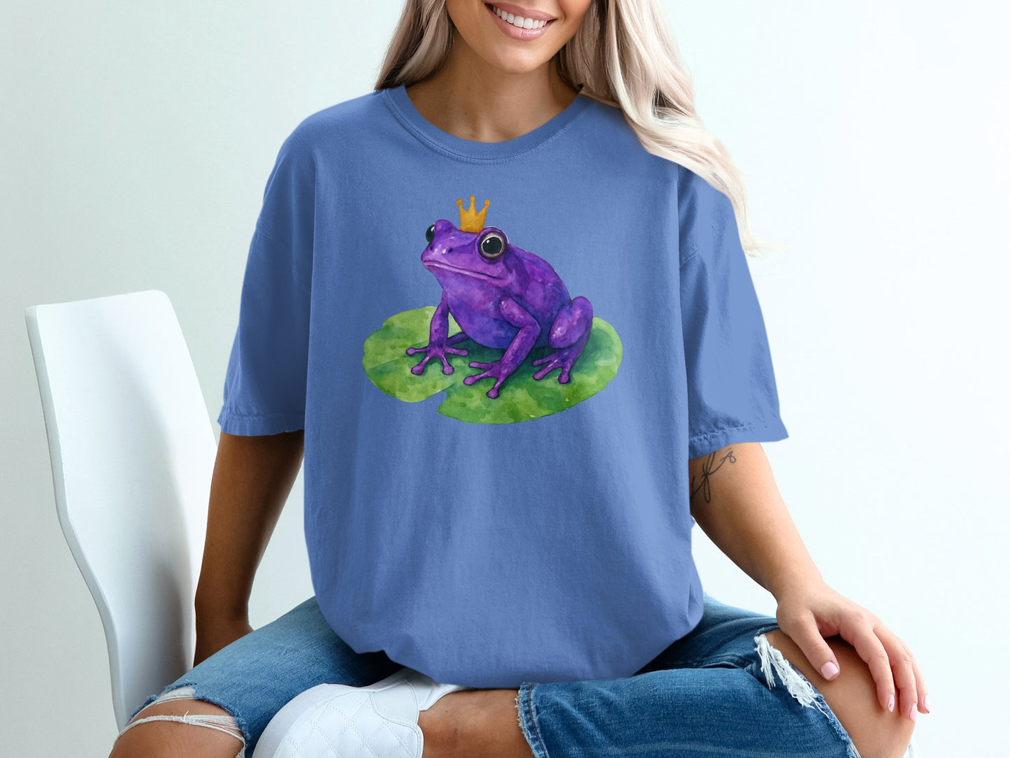 Purple frog wearing a gold crown on a lily pad.