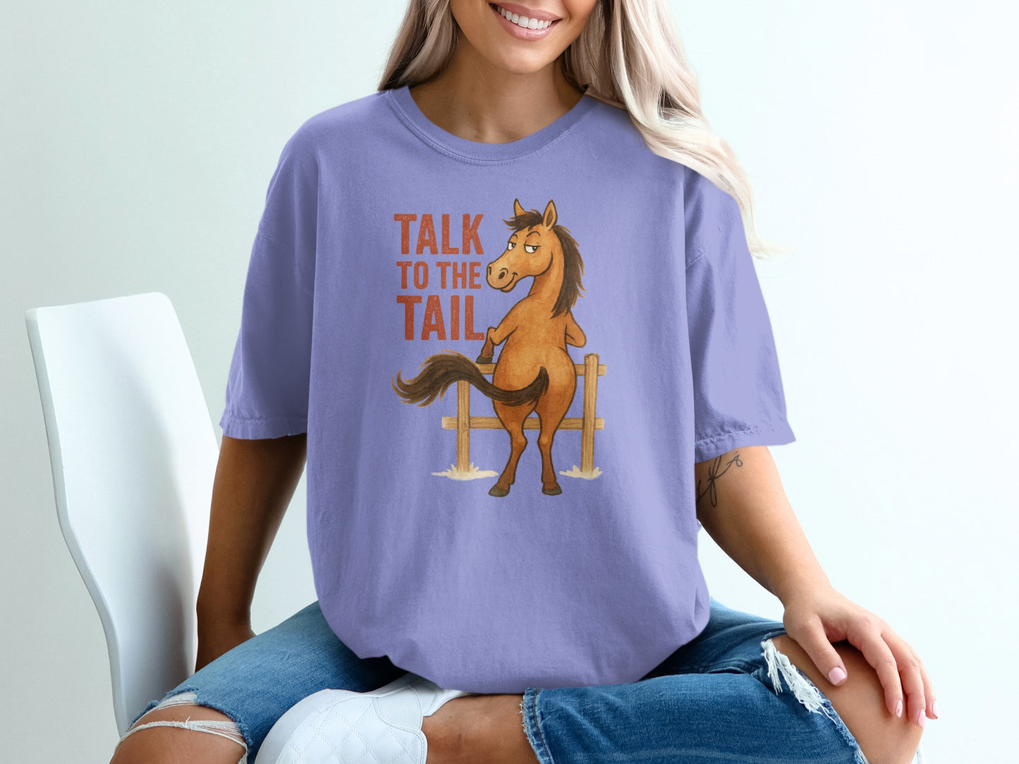 Purple t-shirt with cartoon horse and "Talk to the tail" text.