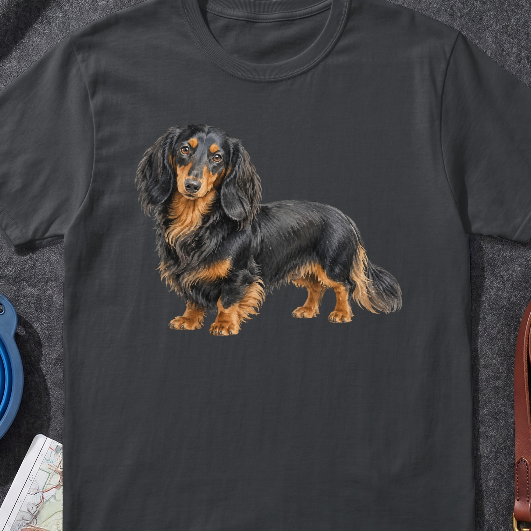 Long-haired black and tan dachshund dog illustration on a dark grey t-shirt.