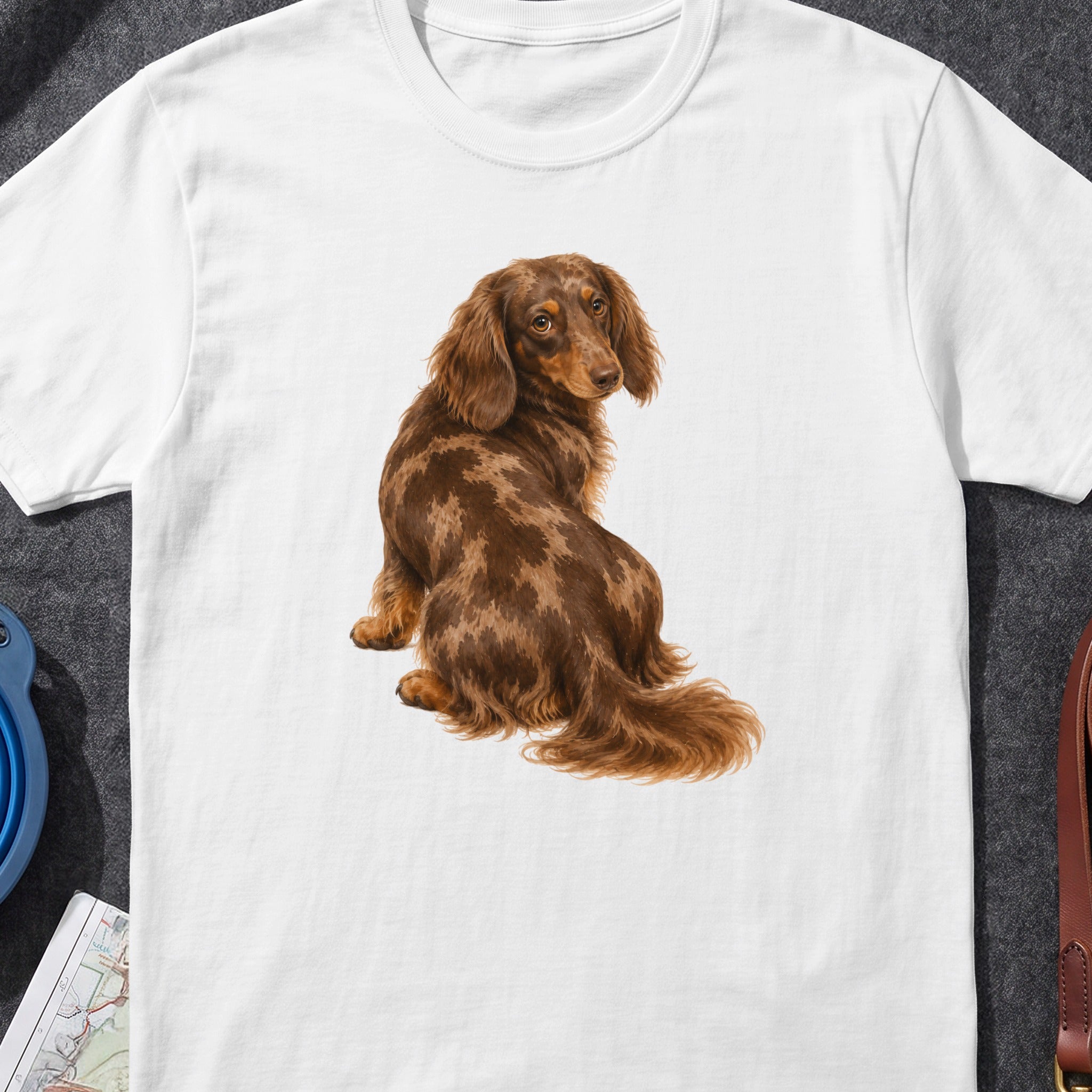 Long-haired dapple dachshund illustration on a white t-shirt.