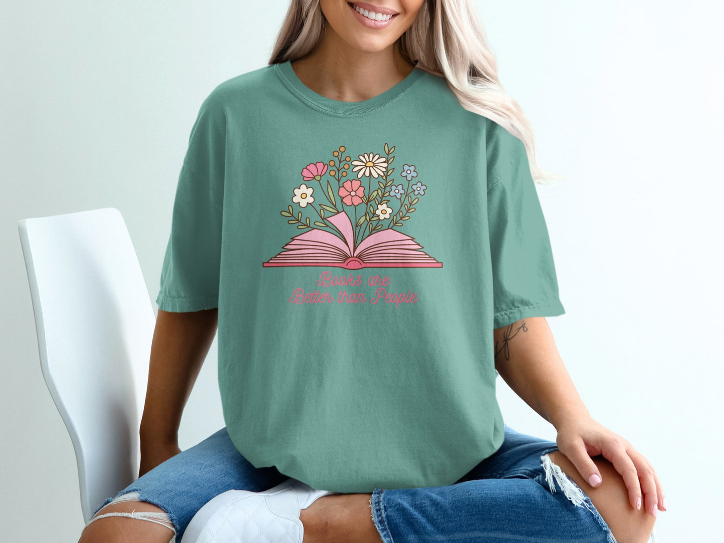 Teal t-shirt with open book and flowers, text "Books are better than people".