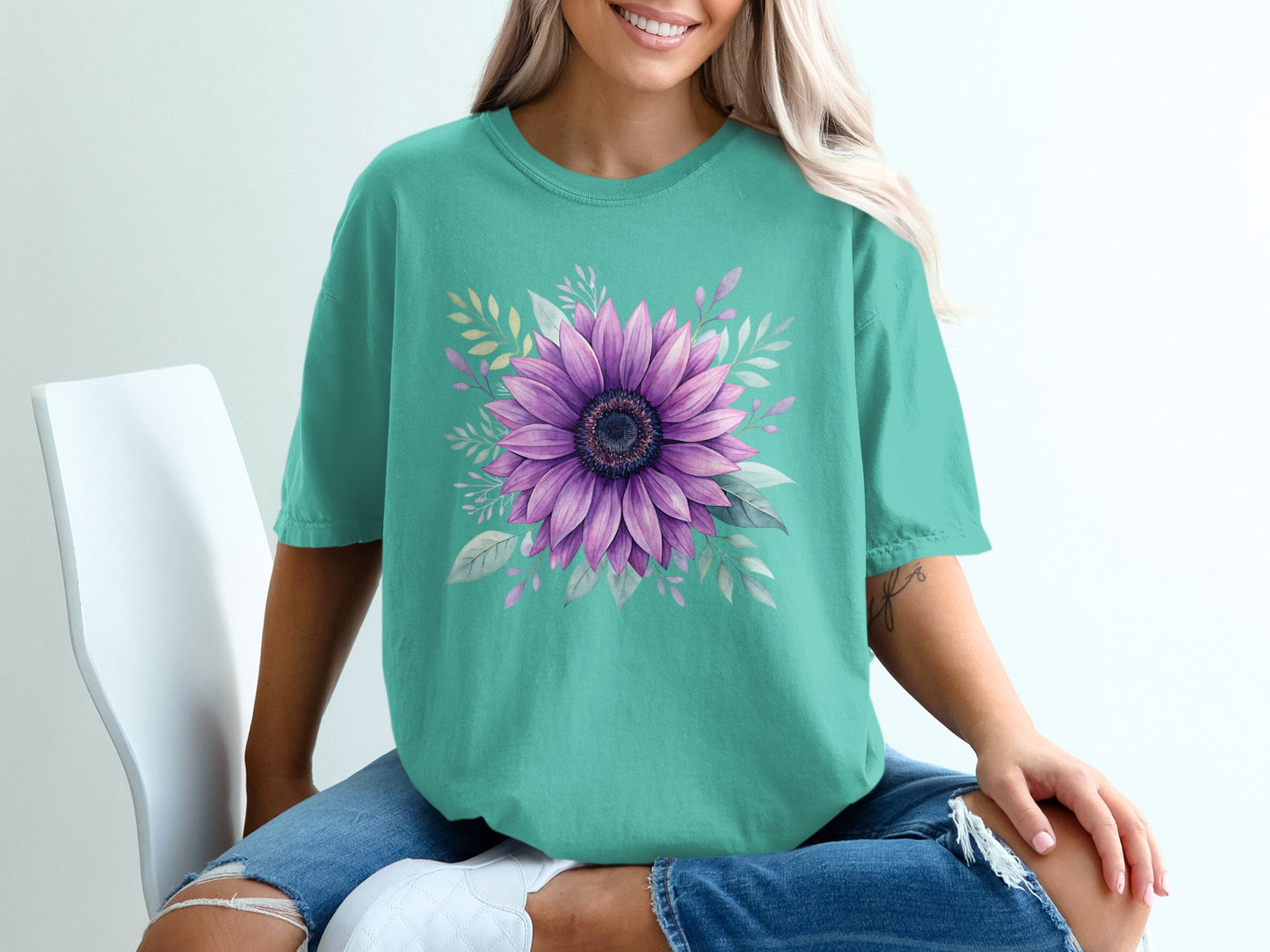 Teal t-shirt with a purple sunflower and green leaves design.