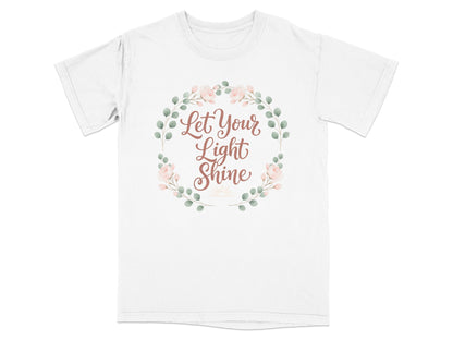 White t-shirt with "Let Your Light Shine" text and floral wreath.