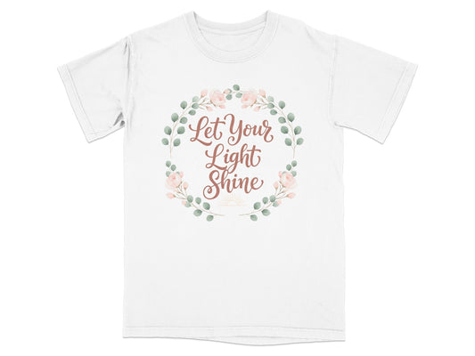 White t-shirt with "Let Your Light Shine" text and floral wreath.