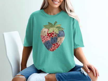Teal t-shirt with a patchwork strawberry graphic.