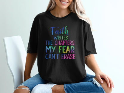 Black t-shirt with rainbow text "Faith writes the chapters my fear can't erase."