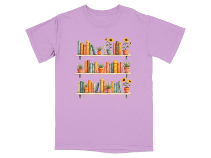 Lavender t-shirt with three shelves of books and potted plants.