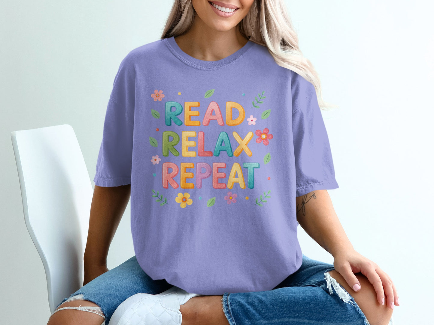 Purple t-shirt with "READ RELAX REPEAT" and floral designs.
