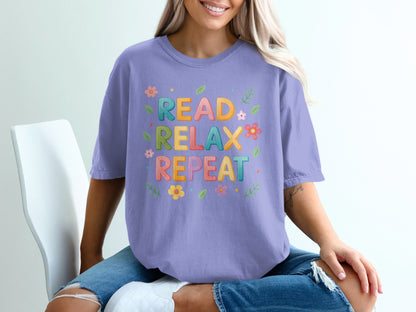 Purple t-shirt with "READ RELAX REPEAT" and floral designs.