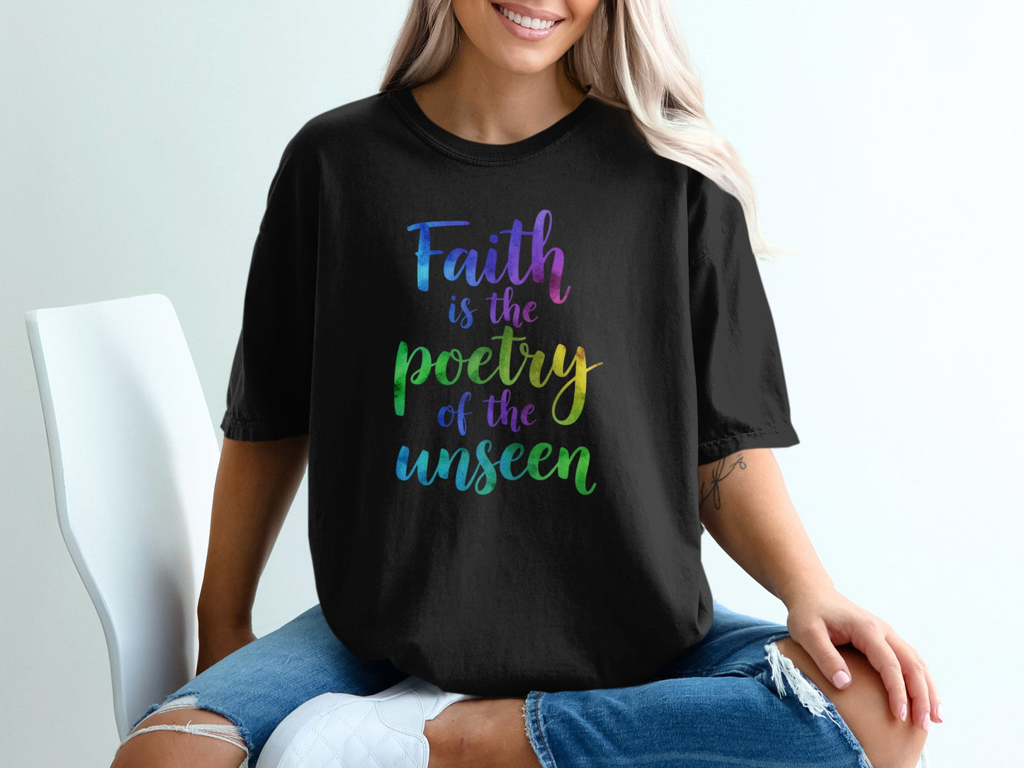 Black t-shirt with "Faith is the poetry of the unseen" text in rainbow colors.
