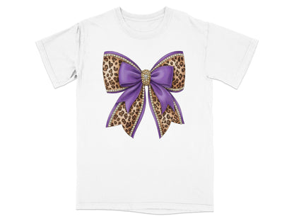 Purple bow with leopard print and rhinestone accents on a white t-shirt.