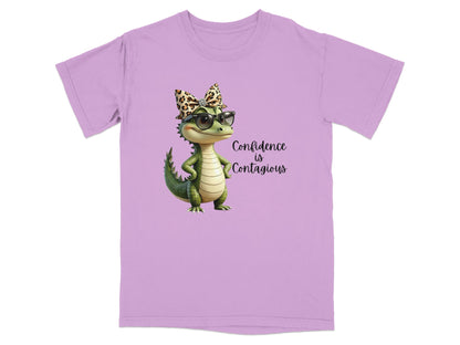 Lavender t-shirt with a cartoon alligator wearing sunglasses and a leopard print bow.