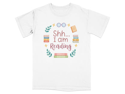 T-shirt with "Shh I am Reading" text and stacked books graphic.