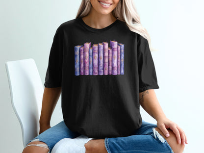 Black t-shirt with watercolor illustration of a shelf of purple and pink books.