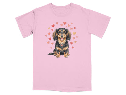 Pink t-shirt with a watercolor illustration of a dachshund wearing a heart pendant.