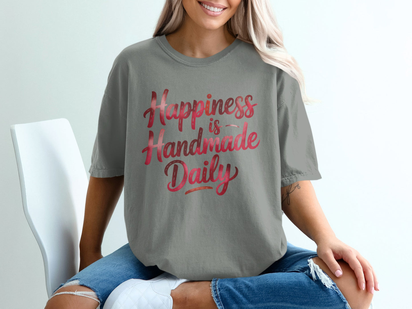 Gray t-shirt with "Happiness is Handmade Daily" in gradient red lettering.