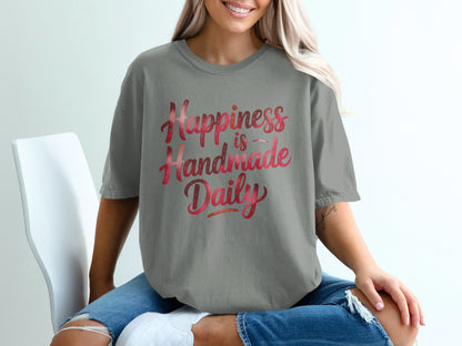 Gray t-shirt with "Happiness is Handmade Daily" in gradient red lettering.