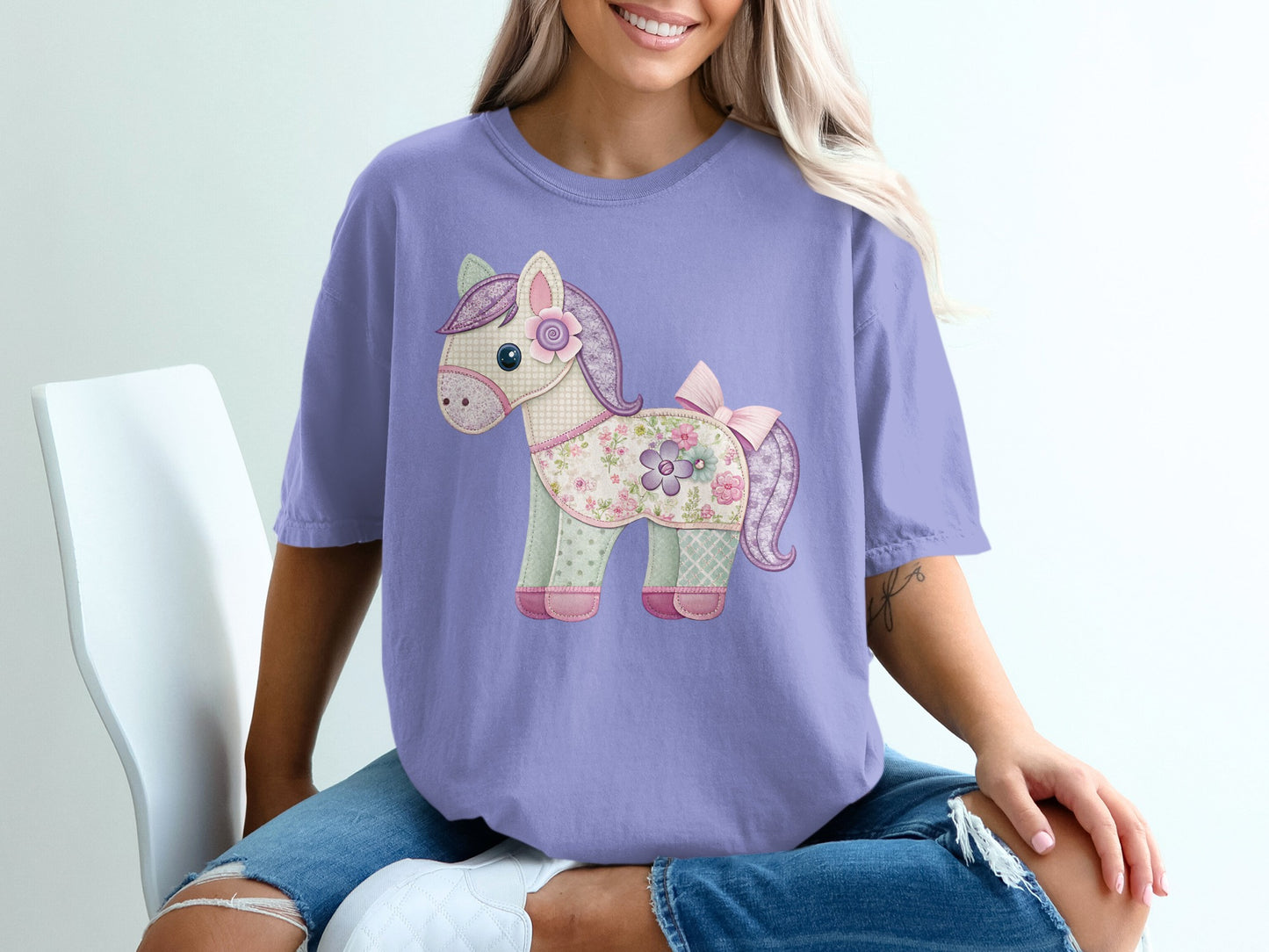 Purple t-shirt with a patchwork horse graphic and pink bow.