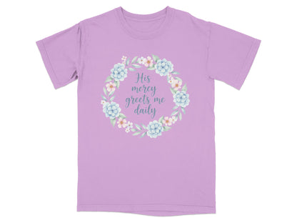 Lavender t-shirt with a floral wreath and text "His mercy greets me daily".